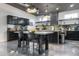 Stylish kitchen with sleek black cabinetry, stainless steel appliances, an island, and polished concrete floors at 2215 N 38Th Way, Phoenix, AZ 85008