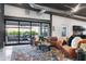 Bright and airy living room with expansive windows, stylish furnishings, and polished concrete floors at 2215 N 38Th Way, Phoenix, AZ 85008