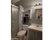 Cozy bathroom featuring a shower, toilet, vanity with sink, and a mirrored medicine cabinet at 2233 E Behrend Dr # 121, Phoenix, AZ 85024