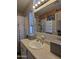 Bathroom vanity with framed mirror and ample natural light at 2233 E Behrend Dr # 121, Phoenix, AZ 85024