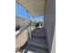 Enjoy a shaded outdoor relaxation area on the covered porch with classic chairs and calming view at 2233 E Behrend Dr # 121, Phoenix, AZ 85024