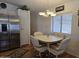 Inviting dining area with a chandelier, stainless steel refrigerator, and plenty of natural light at 2233 E Behrend Dr # 121, Phoenix, AZ 85024