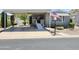 Charming home featuring a covered carport, wheelchair ramp, and manicured landscaping with American flag at 2233 E Behrend Dr # 121, Phoenix, AZ 85024