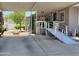 Home featuring a covered carport and ramp leading to the front door, set in a well-maintained community at 2233 E Behrend Dr # 121, Phoenix, AZ 85024