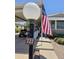 Home exterior featuring an American flag, golf cart, well-kept garden, and accessibility ramp at 2233 E Behrend Dr # 121, Phoenix, AZ 85024