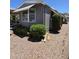 Charming gray home featuring manicured shrubs, providing shade and curb appeal at 2233 E Behrend Dr # 121, Phoenix, AZ 85024