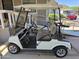 White golf cart parked, offering convenience and mobility for community travel and leisure at 2233 E Behrend Dr # 121, Phoenix, AZ 85024