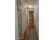 Hallway features wood flooring, a rug runner, and large closet doors, adding warmth and style at 2233 E Behrend Dr # 121, Phoenix, AZ 85024
