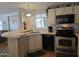 Cozy kitchen featuring stainless steel appliances, breakfast bar, with natural light from the window at 2233 E Behrend Dr # 121, Phoenix, AZ 85024