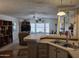 Well-lit kitchen boasts stainless steel sink, neutral countertops, and breakfast bar, flowing into living area at 2233 E Behrend Dr # 121, Phoenix, AZ 85024