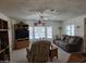 Comfortable living room with plush reclining chair and sofa, ceiling fan, and sun-filled windows at 2233 E Behrend Dr # 121, Phoenix, AZ 85024