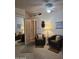 Inviting living room with armchairs, mirrored closet, and ceiling fan at 2233 E Behrend Dr # 121, Phoenix, AZ 85024