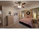 Serene main bedroom with plush carpeting, a ceiling fan, and soft lighting for relaxation at 2233 E Behrend Dr # 121, Phoenix, AZ 85024