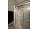 Clean shower featuring white tile, shower head, and sliding doors, ready for refreshing cleansing at 2233 E Behrend Dr # 121, Phoenix, AZ 85024