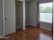 Neutral bedroom with brown flooring, closet, a window, and gray walls offers a serene space at 2233 E Behrend Dr # 17, Phoenix, AZ 85024