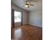 Bedroom features brown flooring, ceiling fan, a window, and gray walls creating a bright, comfortable atmosphere at 2233 E Behrend Dr # 17, Phoenix, AZ 85024