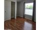 Neutral bedroom with brown flooring, closet, a window, and gray walls offers a serene space at 2233 E Behrend Dr # 17, Phoenix, AZ 85024