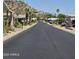 Well-kept community street view with homes featuring mature landscaping at 2233 E Behrend Dr # 17, Phoenix, AZ 85024