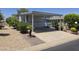 Mobile home featuring a covered carport with lush landscaping at 2233 E Behrend Dr # 17, Phoenix, AZ 85024