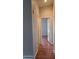 Hallway with hardwood floors and open doorways at 2233 E Behrend Dr # 17, Phoenix, AZ 85024