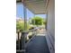 Inviting porch with gray wood flooring, white railing, and lush greenery offers a tranquil outdoor space at 2233 E Behrend Dr # 17, Phoenix, AZ 85024