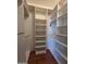 This walk-in closet has custom white storage shelves and clothing racks at 2233 E Behrend Dr # 17, Phoenix, AZ 85024