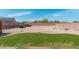 Spacious backyard features gravel, a patch of grass, and parking for multiple vehicles at 22966 W Hopi St, Buckeye, AZ 85326