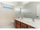 Bathroom with a double sink vanity, white tile, and a shower-tub combination at 22966 W Hopi St, Buckeye, AZ 85326