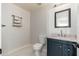 This bathroom has a modern vanity, marble countertop, updated lighting and a decorative shelf at 22966 W Hopi St, Buckeye, AZ 85326