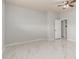 This bedroom features white walls, tiled floors, a ceiling fan, and an open doorway at 22966 W Hopi St, Buckeye, AZ 85326