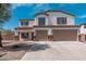 Two-story home featuring a two-car garage, white stucco, and brown trim at 22966 W Hopi St, Buckeye, AZ 85326