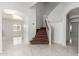 Hallway featuring tile flooring, a staircase, and views into other rooms at 22966 W Hopi St, Buckeye, AZ 85326