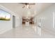 Living room with tile floors opening to kitchen with natural lighting at 22966 W Hopi St, Buckeye, AZ 85326