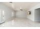 Living room with tile flooring, ceiling fan, and a sliding door at 22966 W Hopi St, Buckeye, AZ 85326