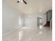 Bright living room featuring tile flooring, a chandelier, and arched doorways at 22966 W Hopi St, Buckeye, AZ 85326