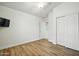 Neutral bedroom with wood-look floors, bright window, and closet at 2402 E 5Th St # 1649, Tempe, AZ 85288