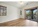 Bright bedroom showcasing wood floors, a wall mounted shelf, and a private outdoor balcony at 2402 E 5Th St # 1649, Tempe, AZ 85288