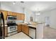 Kitchen featuring stainless steel appliances and wooden cabinets, providing a modern and functional space at 2402 E 5Th St # 1649, Tempe, AZ 85288