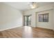 Large main bedroom featuring wood floors, a window and balcony access at 2402 E 5Th St # 1649, Tempe, AZ 85288