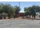 Red home amongst the trees on a sunny day at 25449 W Pueblo Ave, Buckeye, AZ 85326