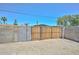 A backyard with a privacy fence, wooden gate, and desert landscaping at 2922 W Citrus Way, Phoenix, AZ 85017