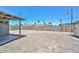 A backyard featuring a covered patio, block wall, and privacy gate at 2922 W Citrus Way, Phoenix, AZ 85017