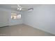 Sunlit bedroom has tile flooring, ceiling fan, and mini-split AC at 2922 W Citrus Way, Phoenix, AZ 85017