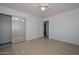 Bedroom displaying tile floors, a ceiling fan, mirrored closets, and entry door at 2922 W Citrus Way, Phoenix, AZ 85017