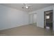 Bedroom displaying tile floors, a ceiling fan, mirrored closets, and an entry door at 2922 W Citrus Way, Phoenix, AZ 85017