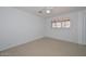 Well-lit bedroom featuring tile floors, a ceiling fan, and a bright window at 2922 W Citrus Way, Phoenix, AZ 85017