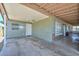 A spacious carport with a wooden ceiling and a door that leads to a screened porch at 2922 W Citrus Way, Phoenix, AZ 85017