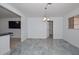 Open dining room boasts stylish light fixture and beautiful marble-look tile flooring at 2922 W Citrus Way, Phoenix, AZ 85017