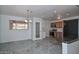 An open-concept kitchen and dining area with modern stainless steel appliances and tile flooring at 2922 W Citrus Way, Phoenix, AZ 85017