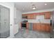 Updated kitchen with stainless steel appliances, warm wood cabinets, and marble-look tile floor at 2922 W Citrus Way, Phoenix, AZ 85017